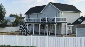 Custom home remodeling project by Hanson Home Works Inc in Davis County featuring an elevated outdoor deck with white railings, structural upgrades, and enhanced exterior living space on a residential property.